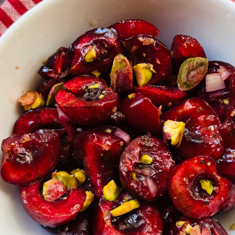 Cherry salad with pistachios in a white bowl