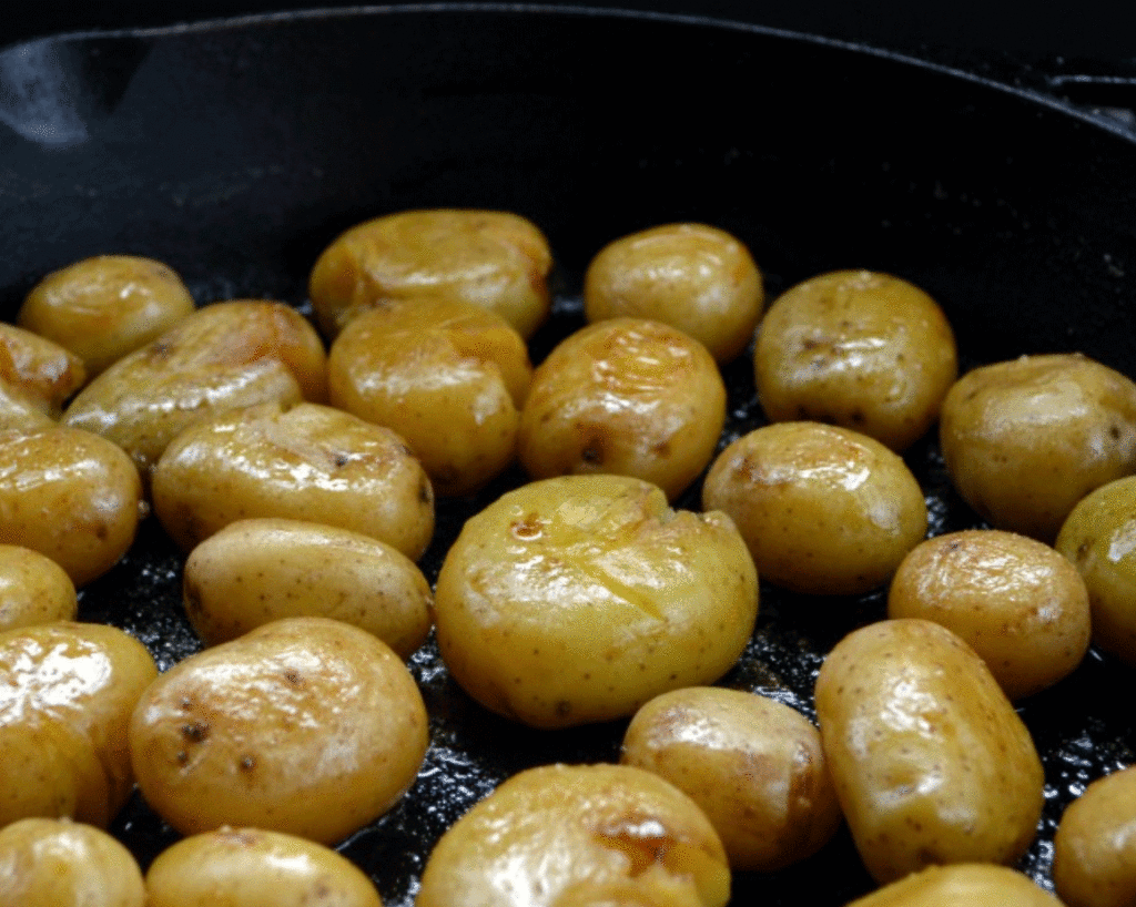 A cast iron skillet full of roasted potatoes