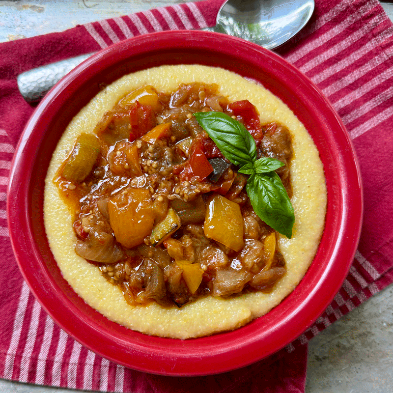 Ratatouille in a bowl served over yellow grits
