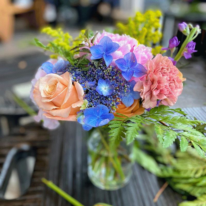 Fresh flower bouquet with roses and hydrangeas in a vase